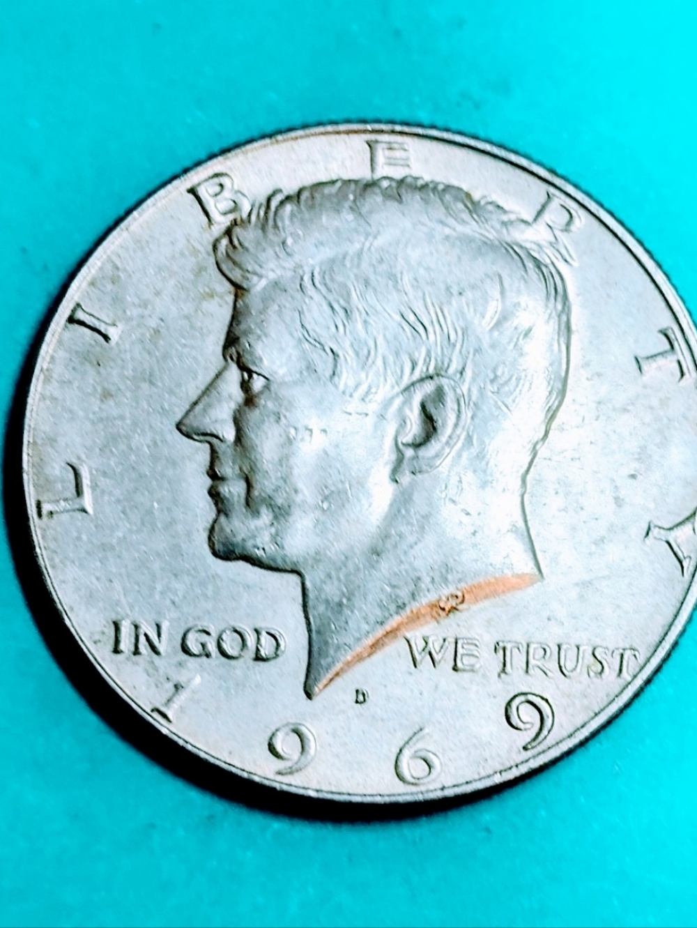 1969-D 40% Silver Kennedy Half Dollar In Very Good Circulated Condition.